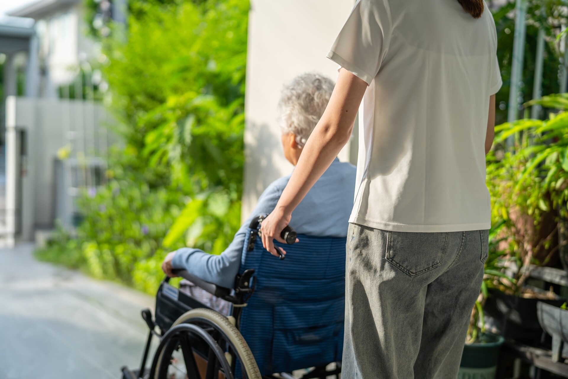woman-pushing-senior-in-wheelchair-outdoors-2026-03-24-11-39-10-utc
